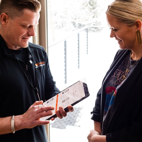 Contractor discussion options with a homeowner on an ipad