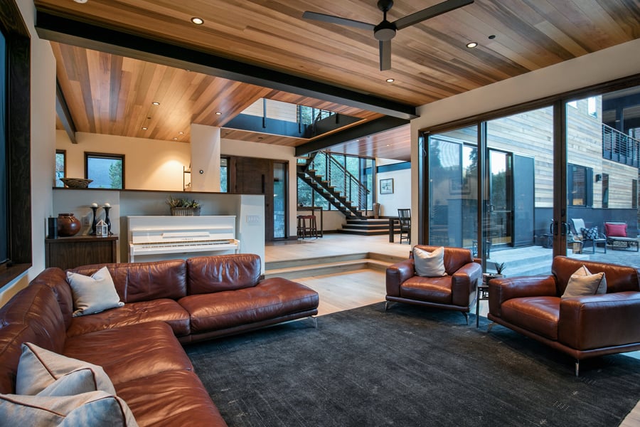 Modern living area with large opening leading out to a patio